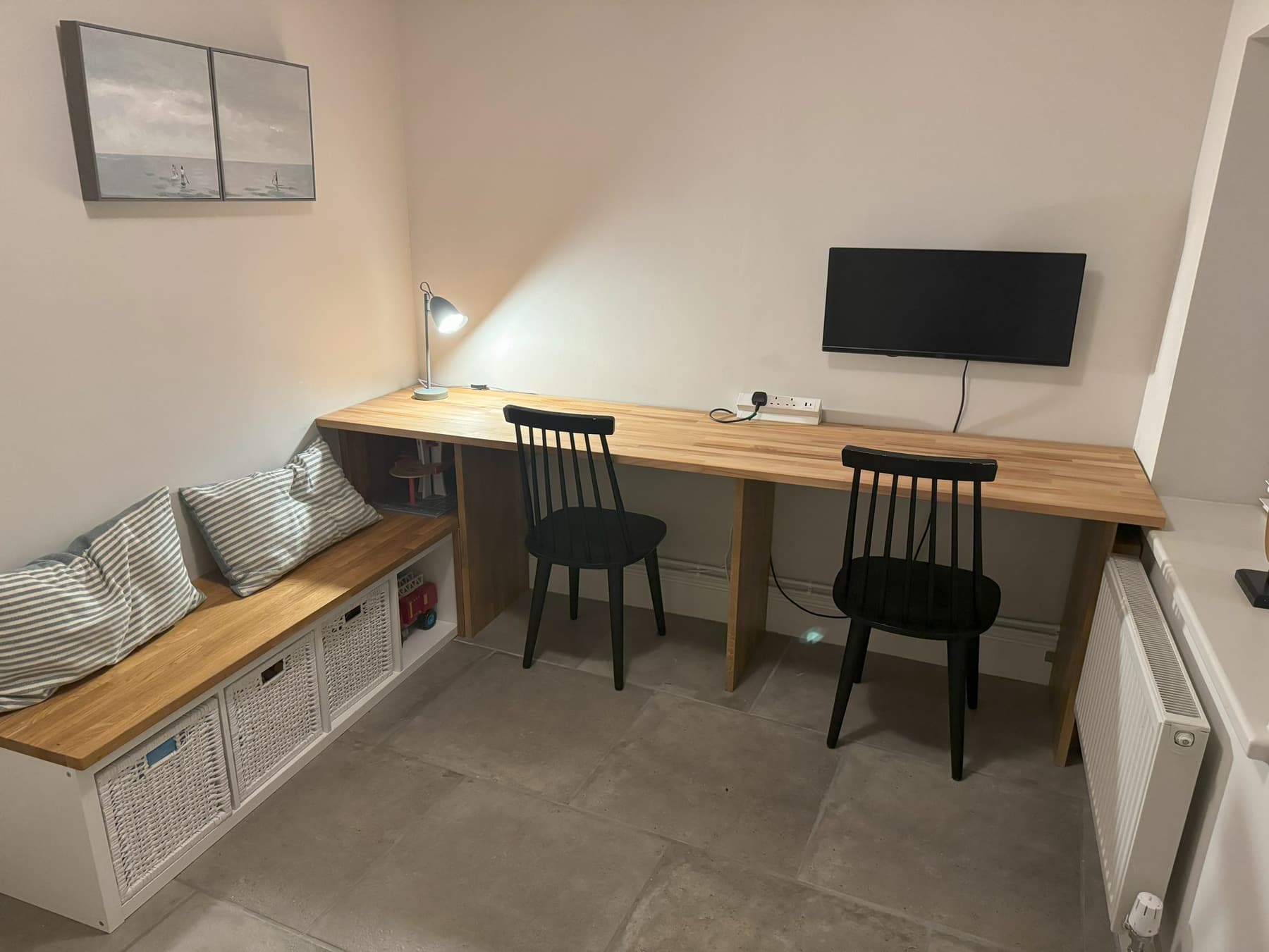 The long desk set up as a shared work bench