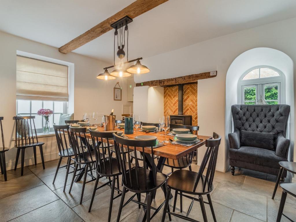 The long dining table and log burner, set for a full team